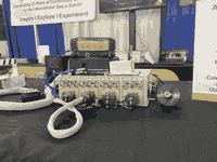 The ISS radio system, with a display, black radio box and off-white power supply system with 4 ports.