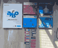 Five software boxes and 13 memory sticks, blue, white, pink, and purple in color.